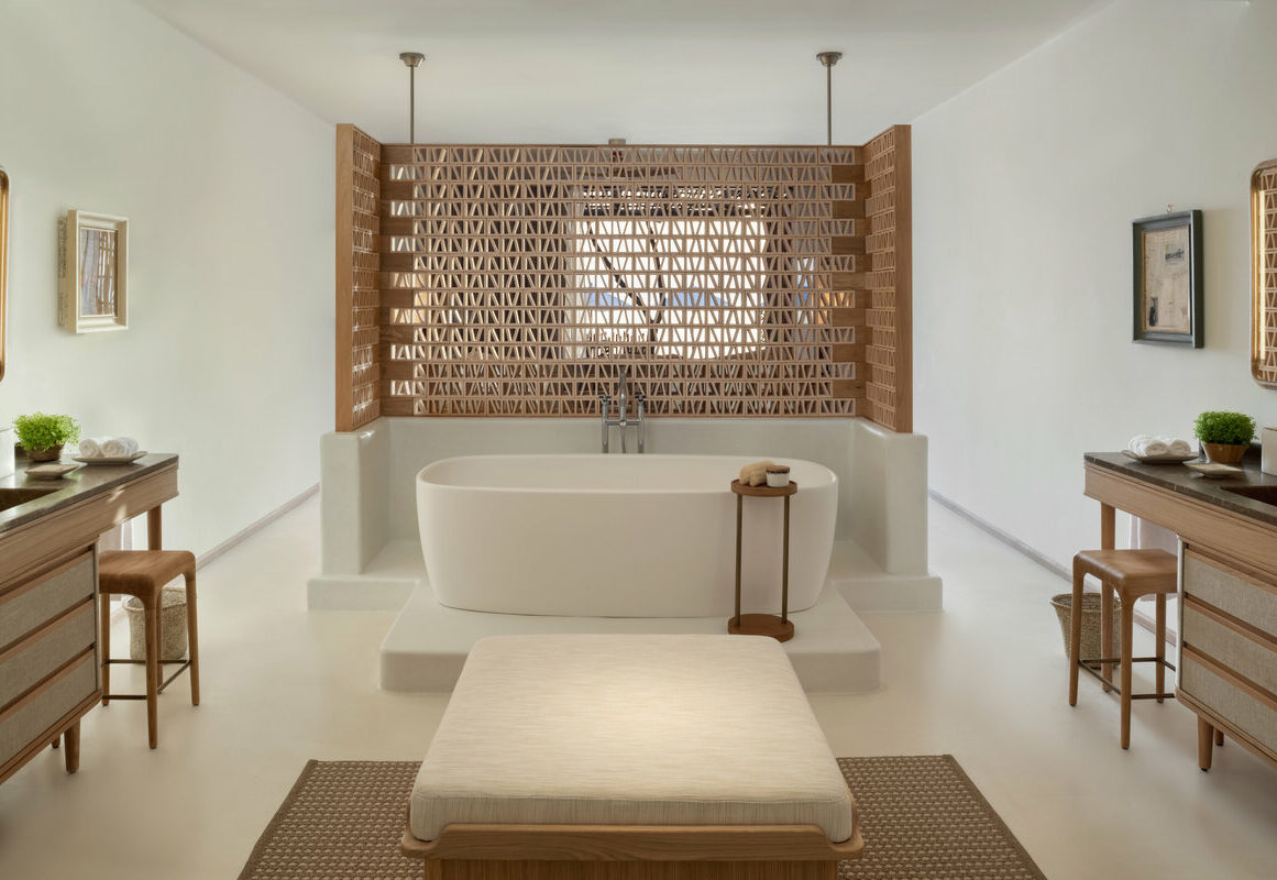 a bathtub and a bench in a room