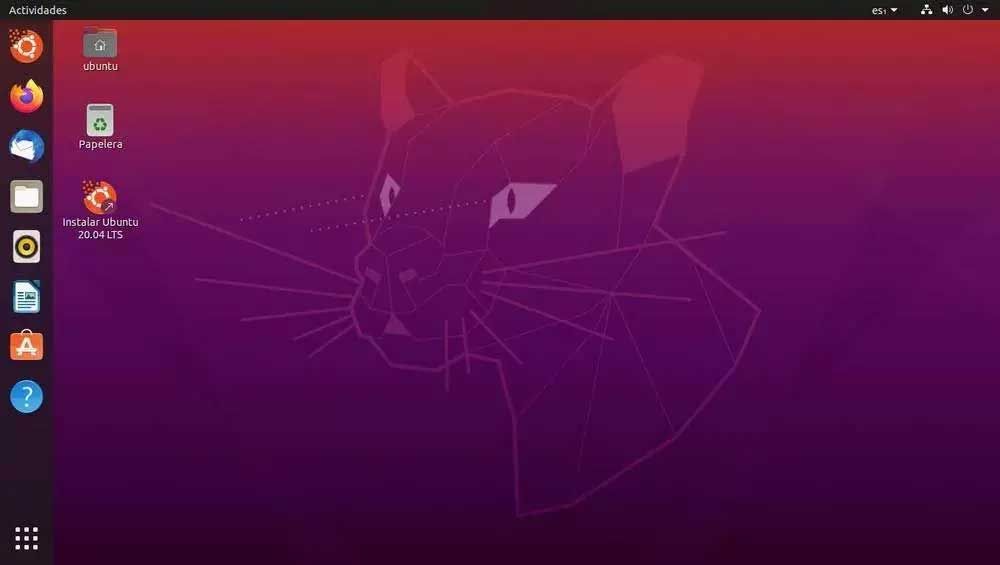 Escritorio de Ubuntu 24.04 LTS con iconos laterales, barra superior y fondo morado con silueta de felino.