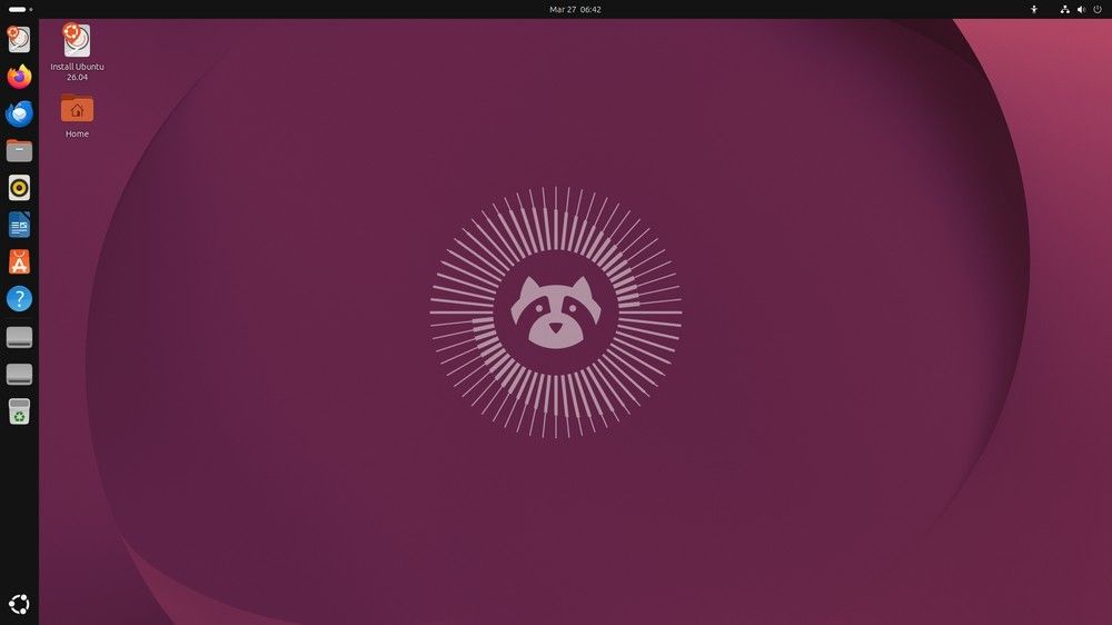 Captura de pantalla del escritorio de Ubuntu con el tema oscuro, iconos en el lateral izquierdo y el logo de la mascota en e.