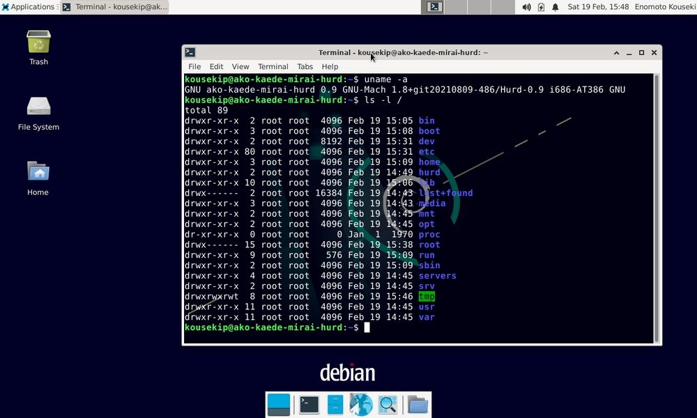 Terminal abierta en un escritorio Debian GNU/Hurd mostrando comandos del sistema sobre un fondo azul oscuro.